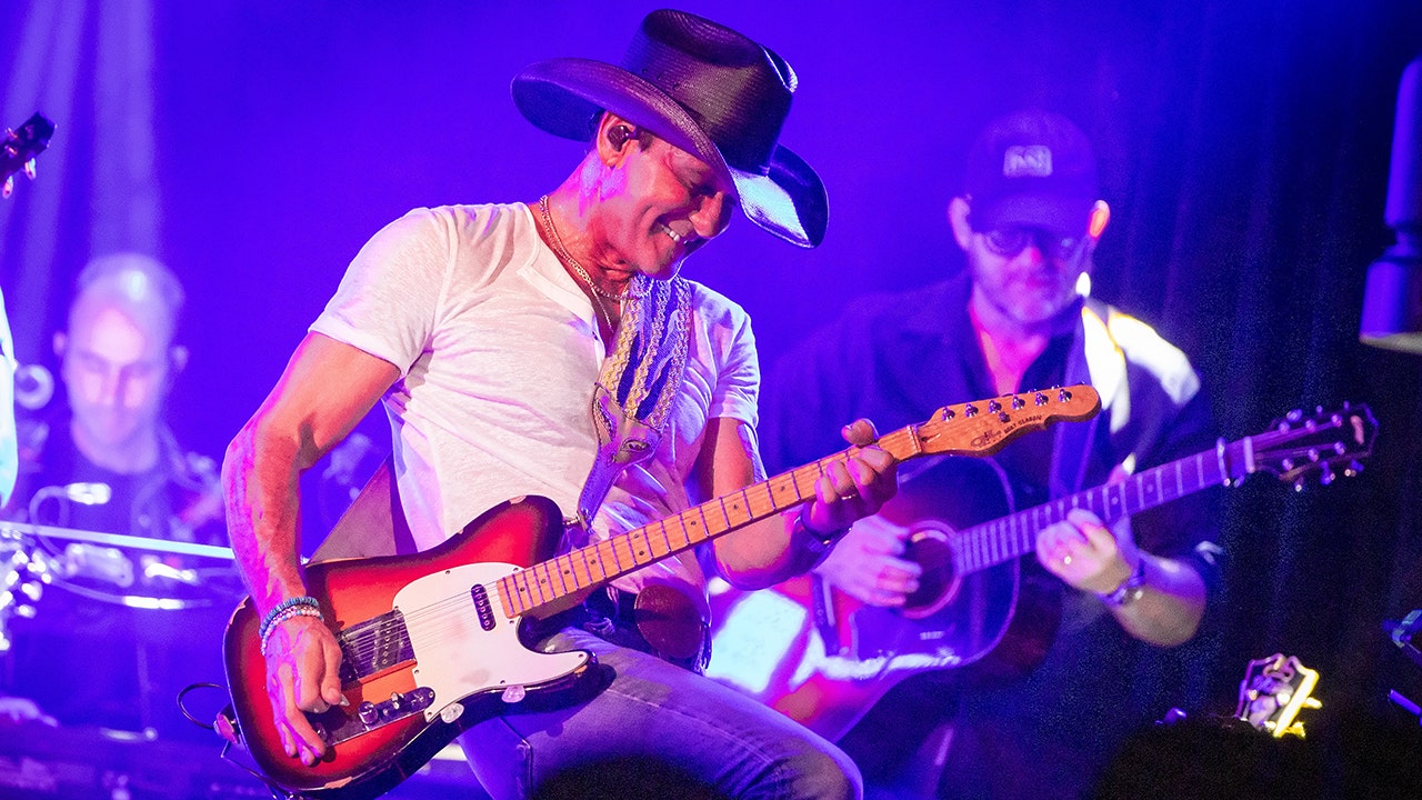 Tim McGraw performing on stage at Whiskey Go Go