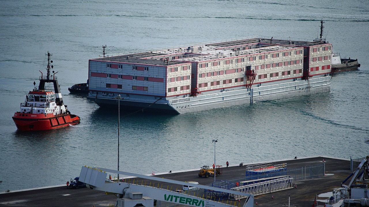 Barge that will house around 500 asylum seekers arrives in England after Parliament passes migration bill