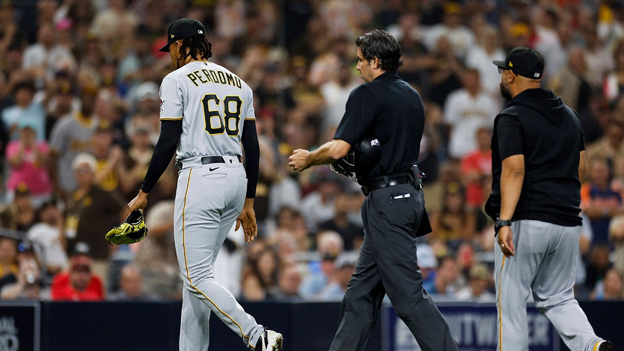 Angel Perdomo escorted off the field