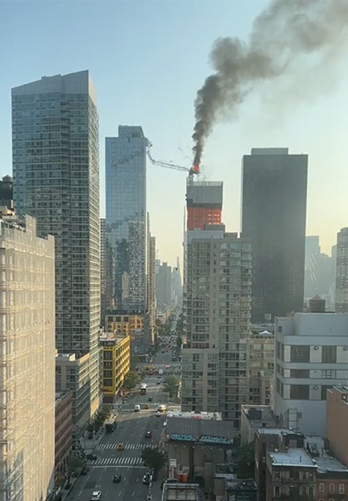 Crane collapsing and hitting a building.