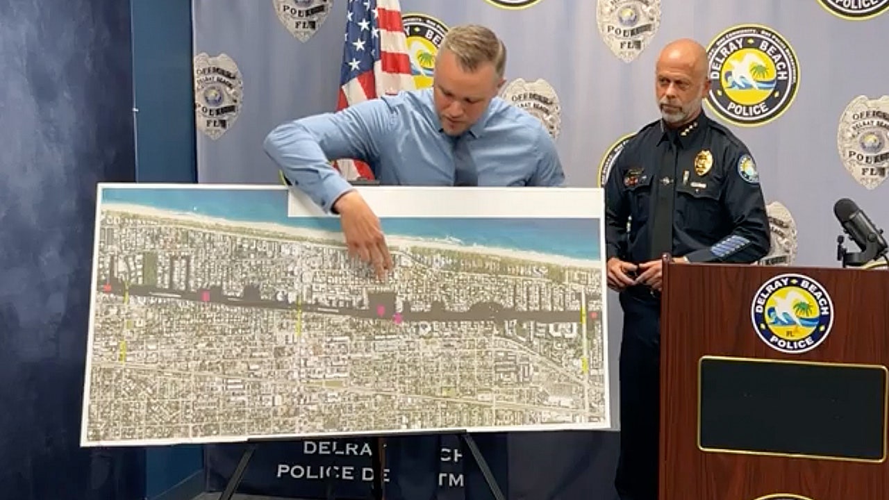 Delray Beach police standing next to map displaying the location of suitcases.