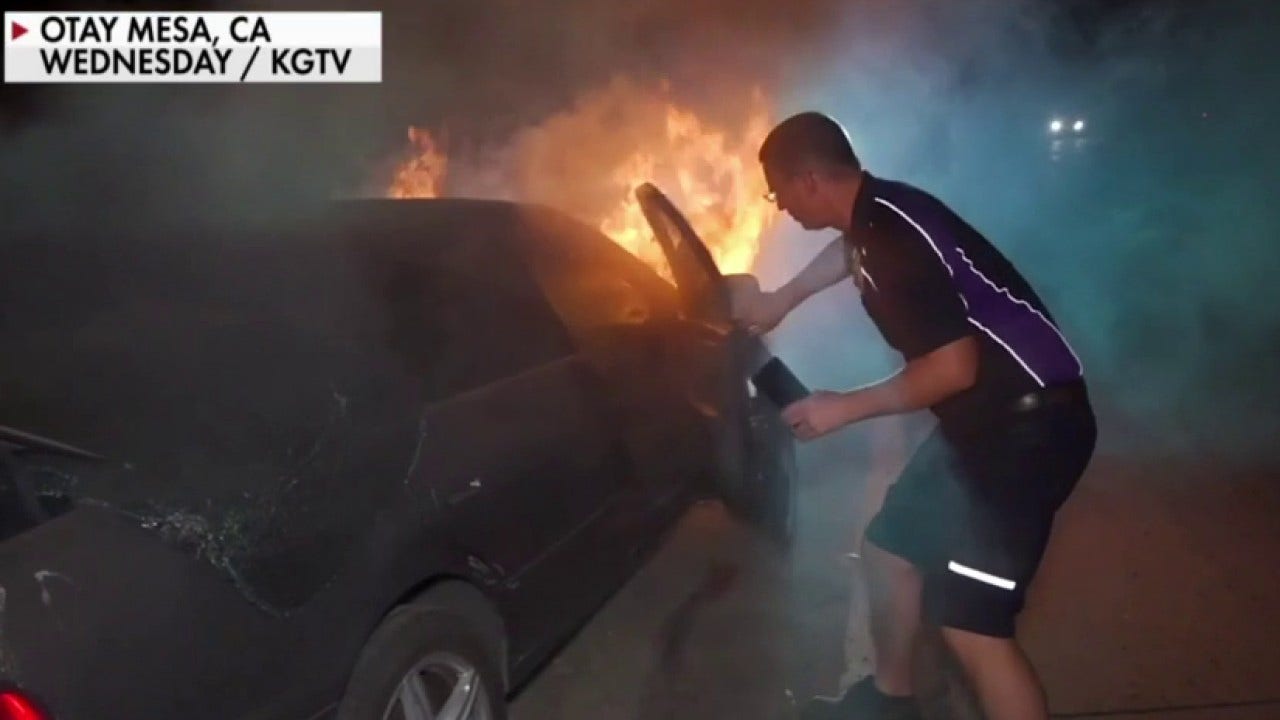 FedEx driver looks into burning car