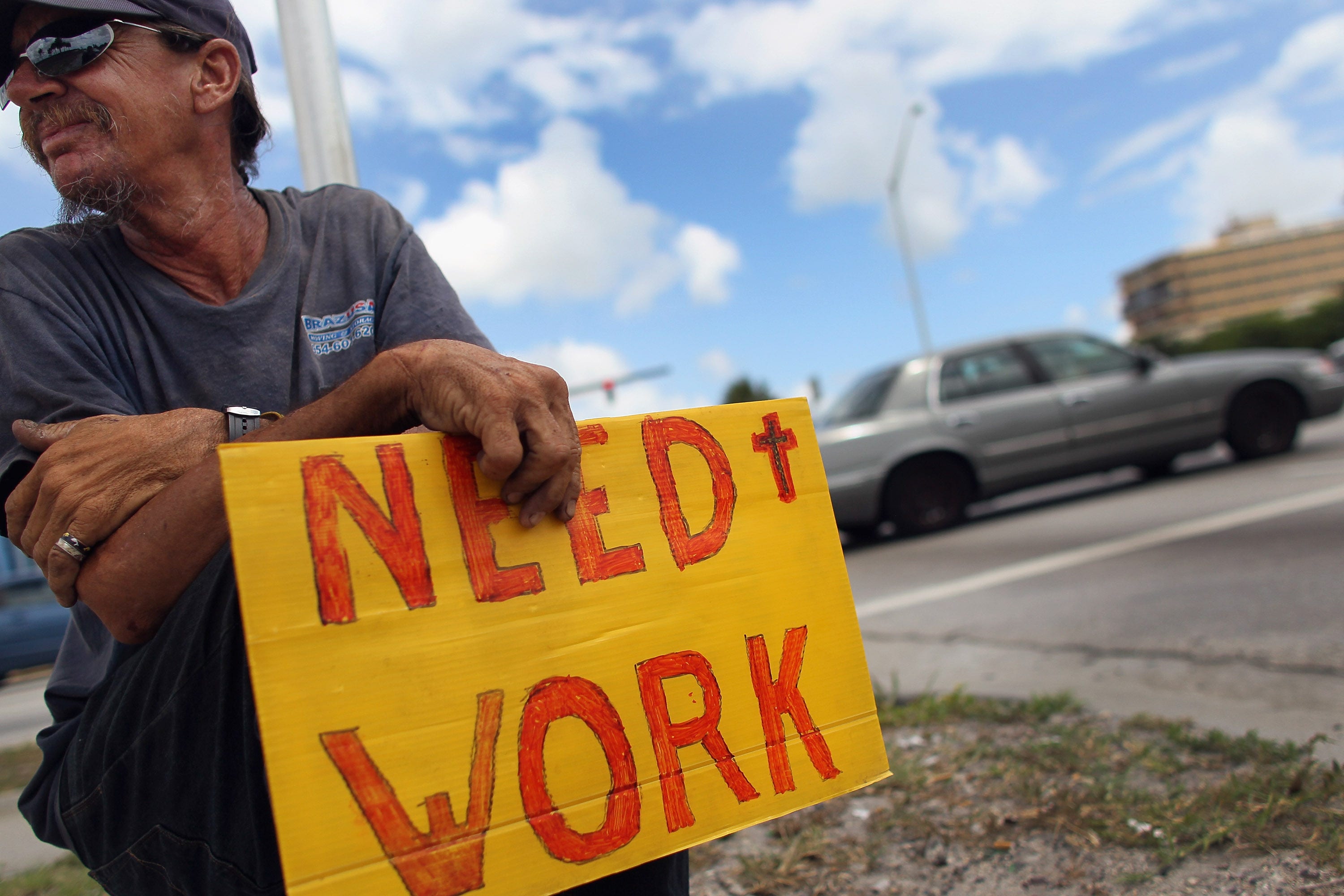 Stephen Greene works a street corner hoping to land a job as a laborer or carpenter on June 3, 2011 in Pompano Beach, Florida.