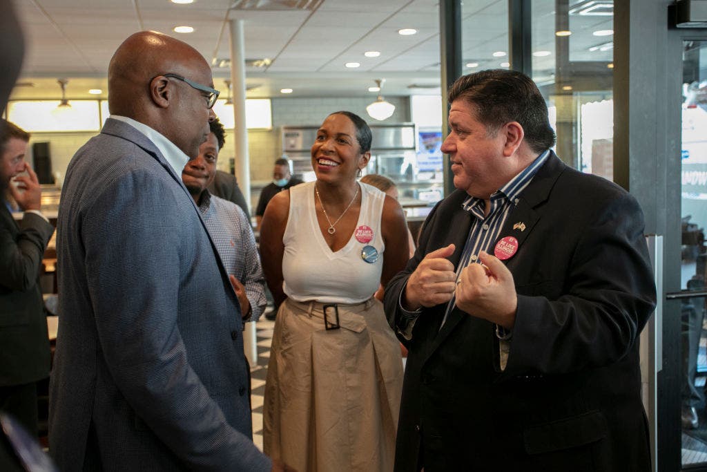  Illinois Governor J.B. Pritzker (R) and Illinois Lieutenant Governor Juliana Stratton (C) speak to Illinois Attorney General Kwame Raoul (L) on Primary Day at Manny's Deli on June 28, 2022 in Chicago, Illinois. 