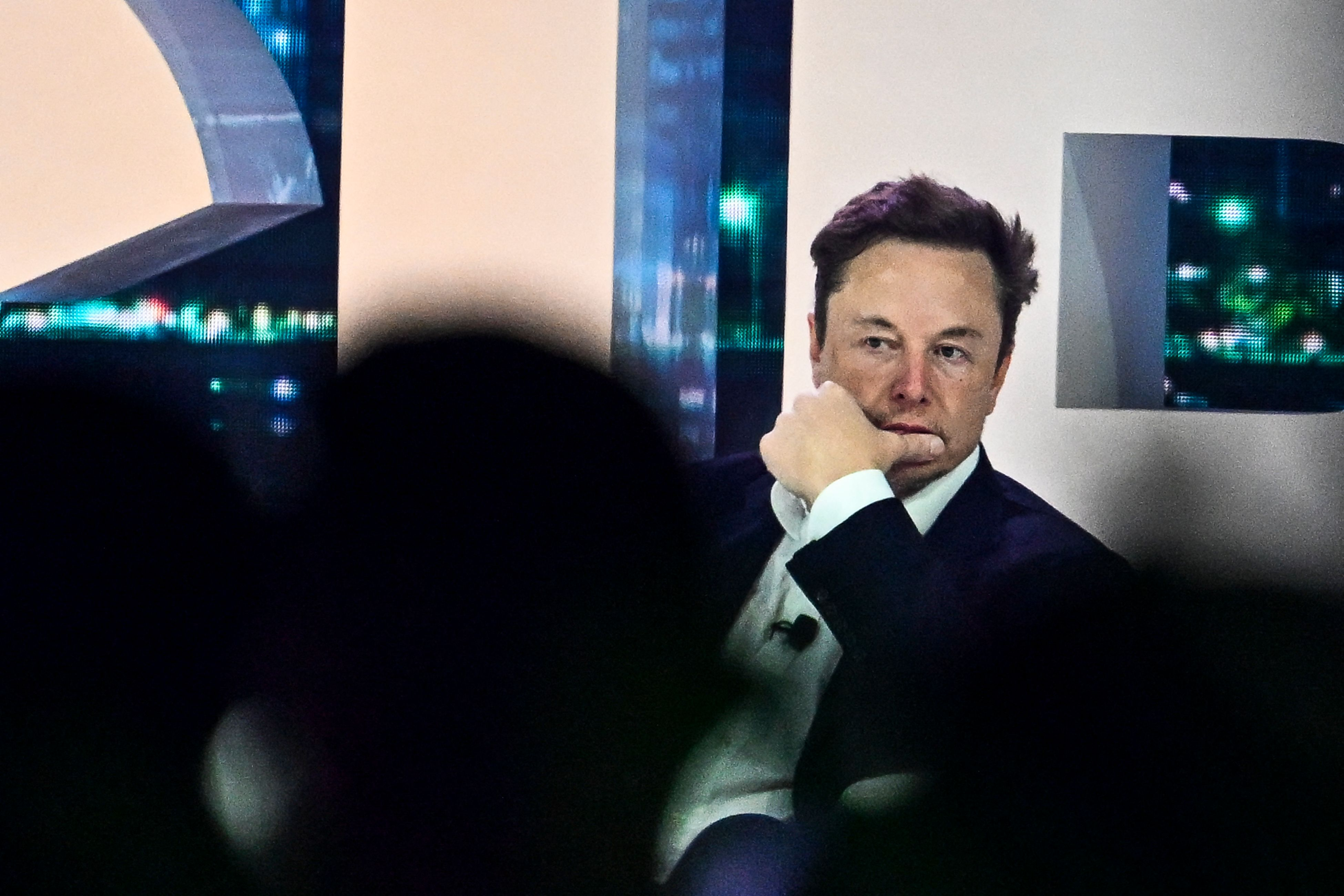 Elon Musk sitting down at conference talking about twitter 2.0