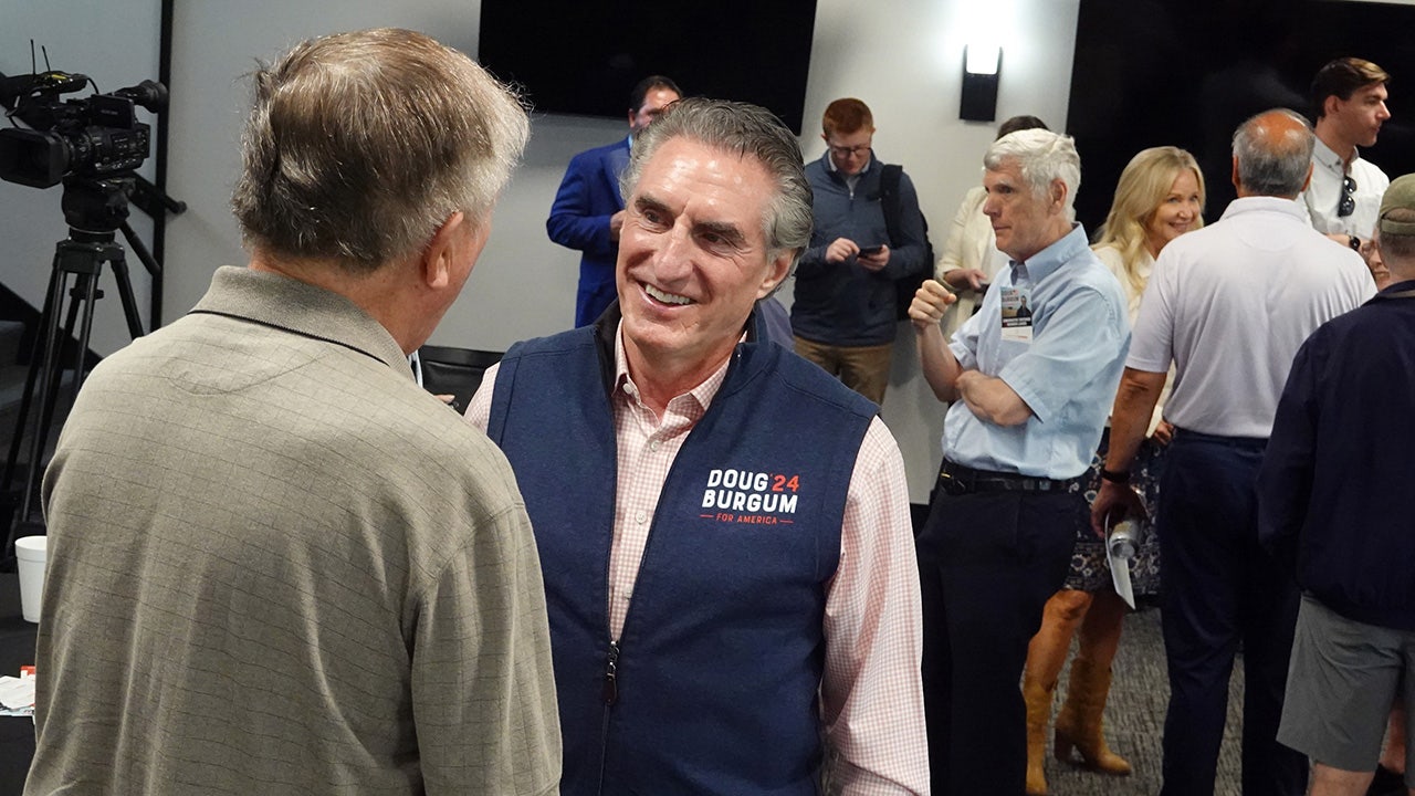 Doug Burgum speaks to a potential Iowa caucus voter