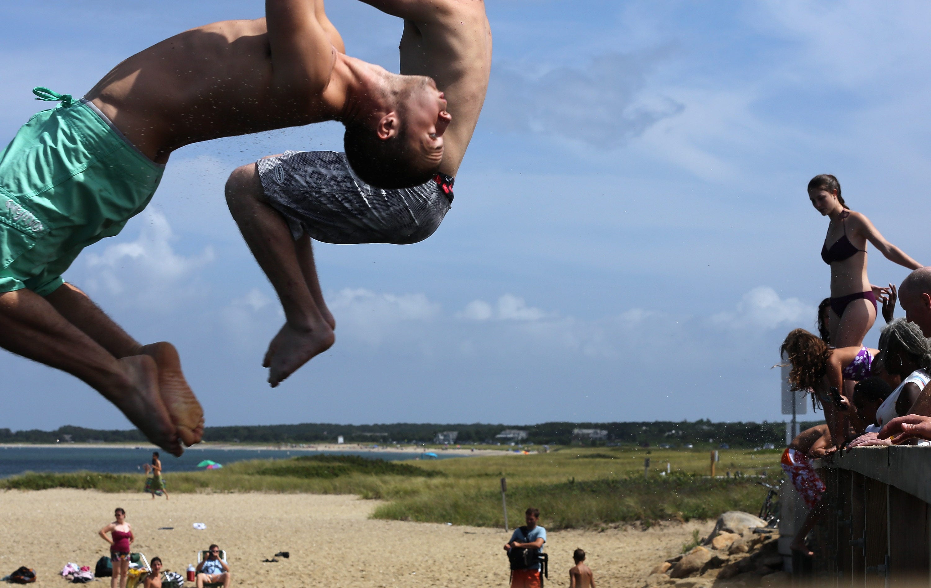 People jump off 'Jaws Bridge' during JawsFest