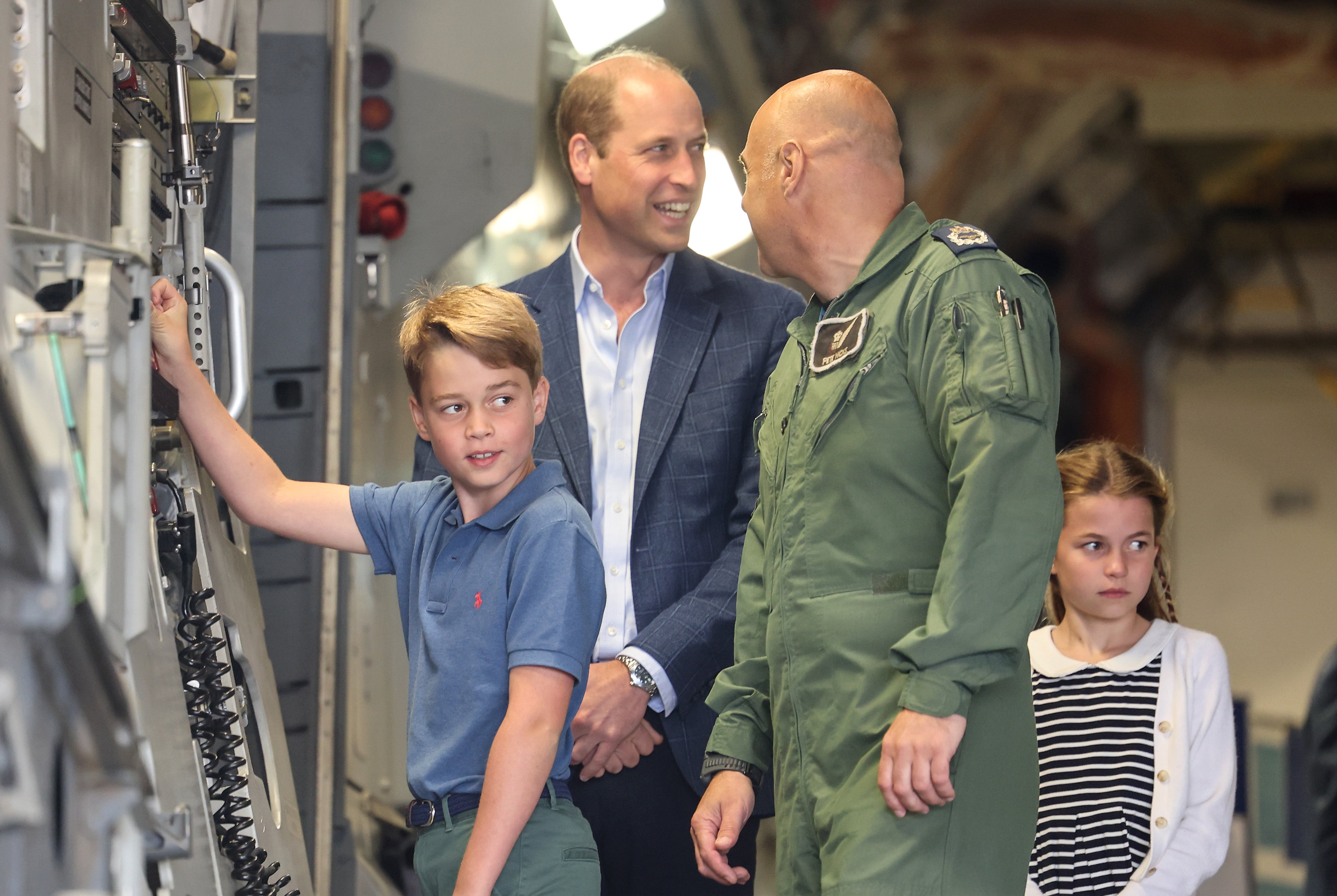 A photo of Prince William and Prince George looking at aircraft controls