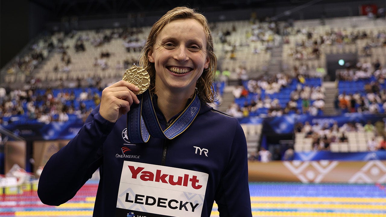 Katie Ledecky poses with the gold medal