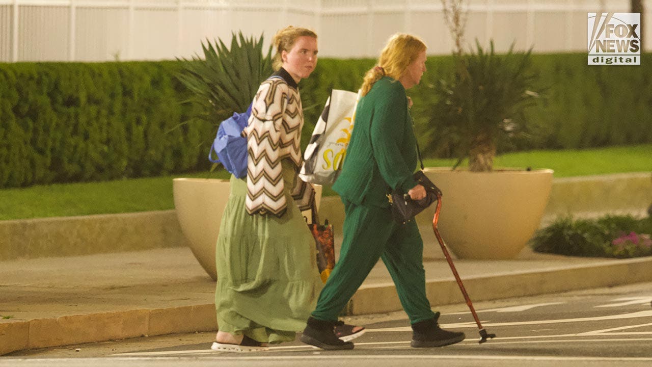 Rex Heuermann's wife, Asa Ellerup and daughter, Victoria Heuermann walk on the street