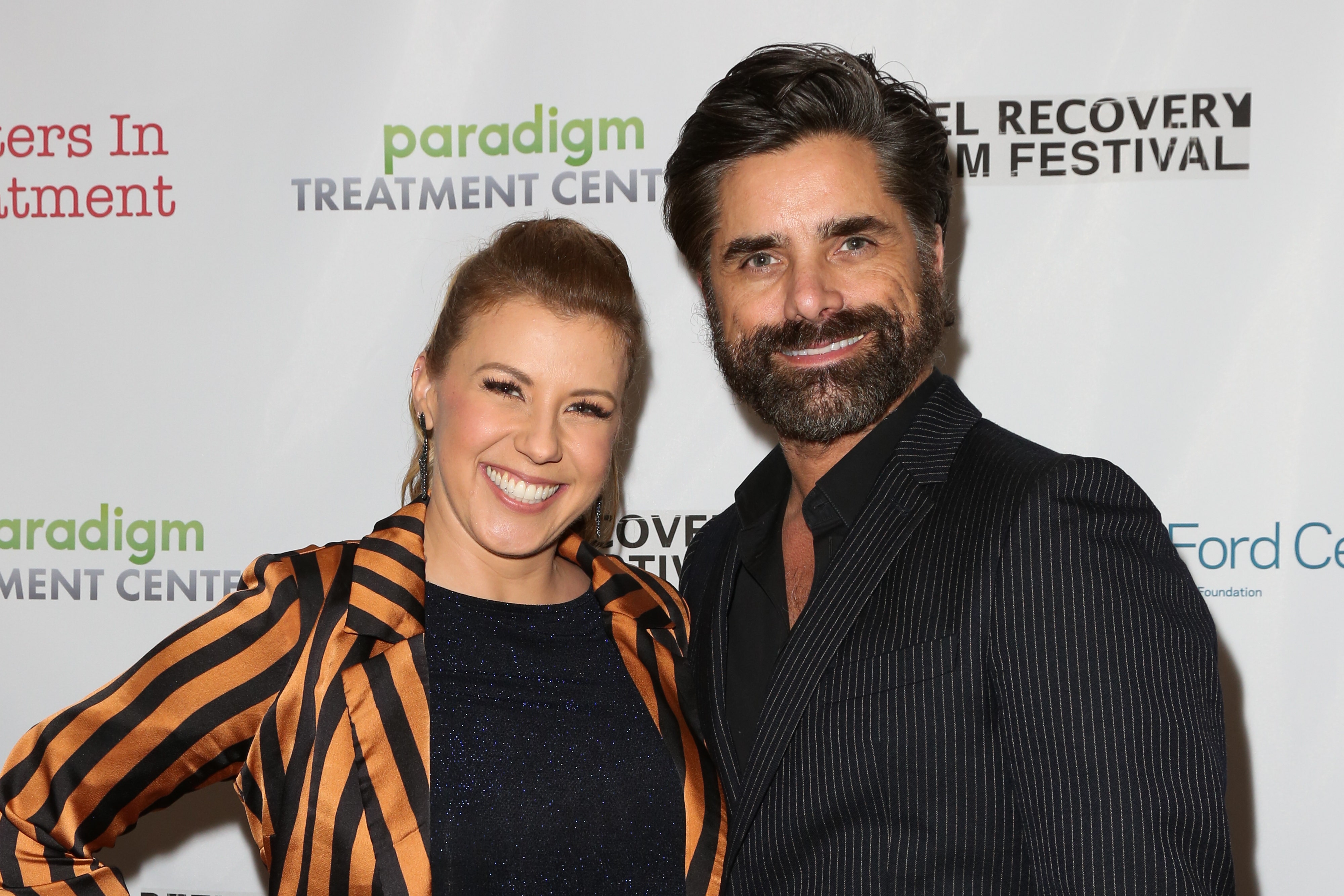 Jodie Sweeten smiles and poses with John Stamos.