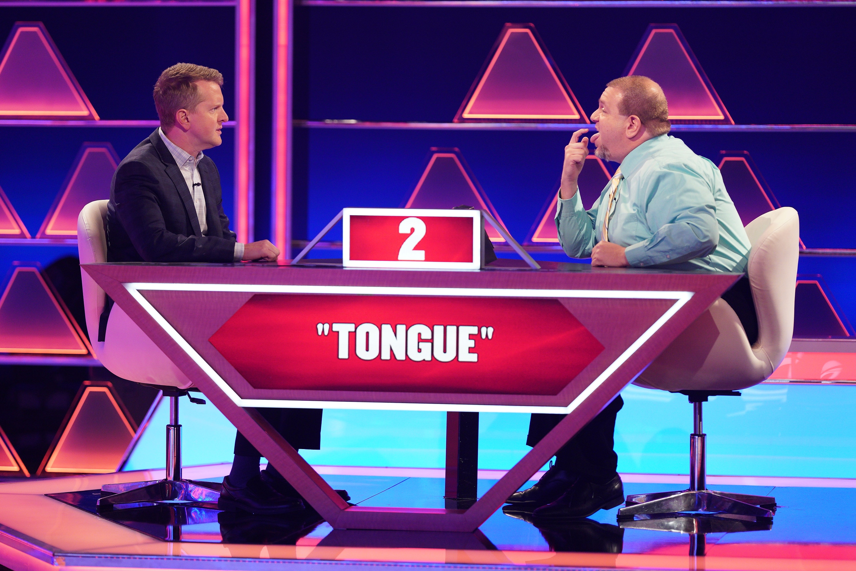 Ken Jennings sits across from a contestant on The $100,000 Pyramid