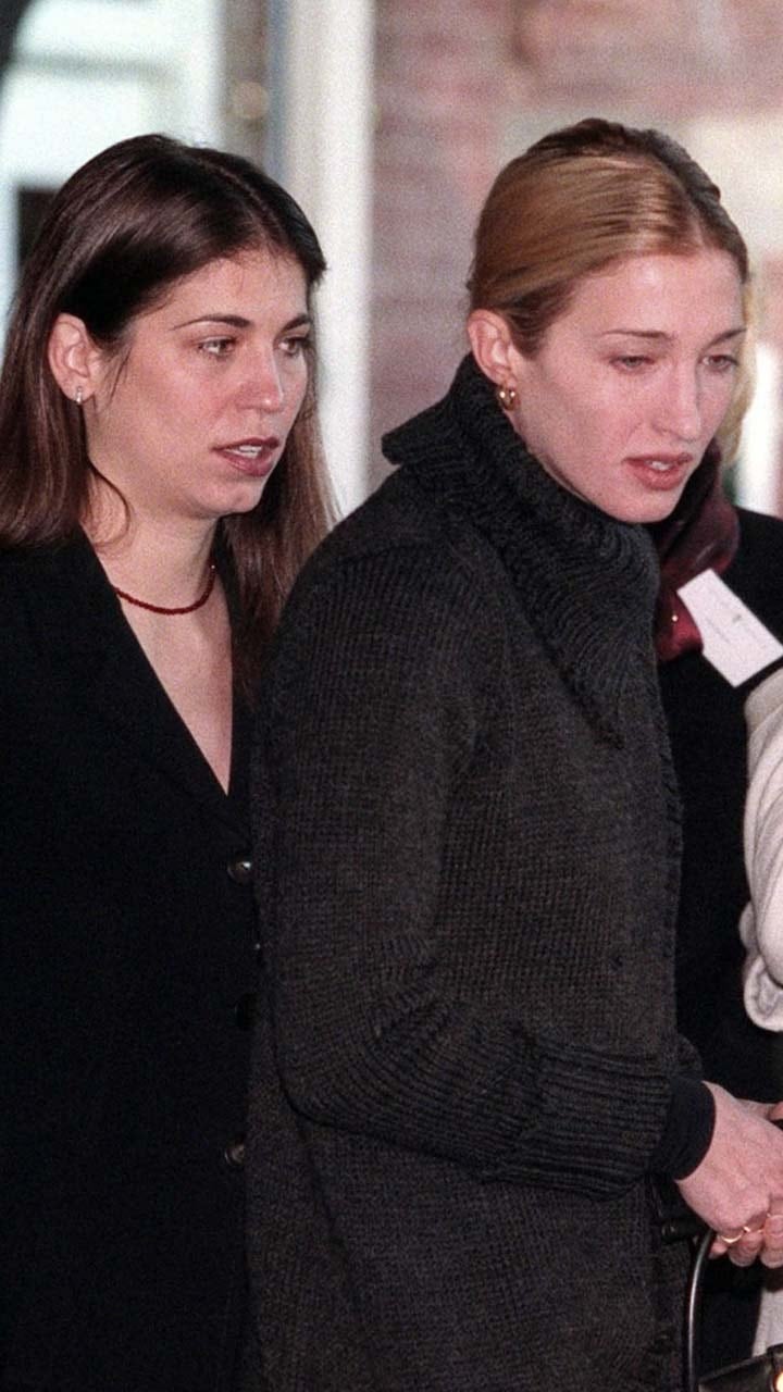 Carolyn and Lauren Bessette in dark coats walking