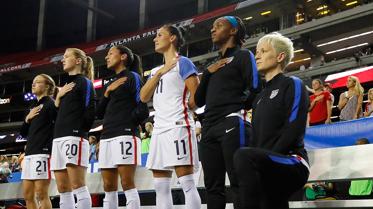 Megan Rapinoe kneels during the National Anthem
