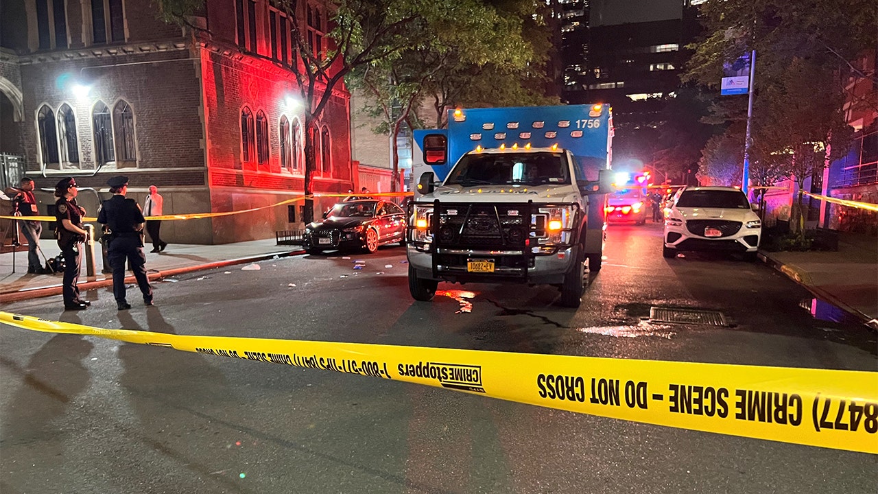 Ambulance parked behind crime scene tape