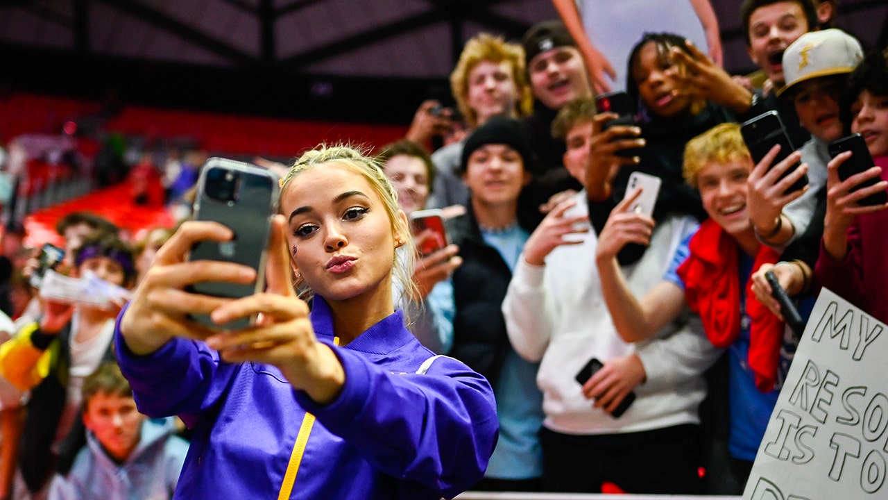 Olivia Dunne poses with fans