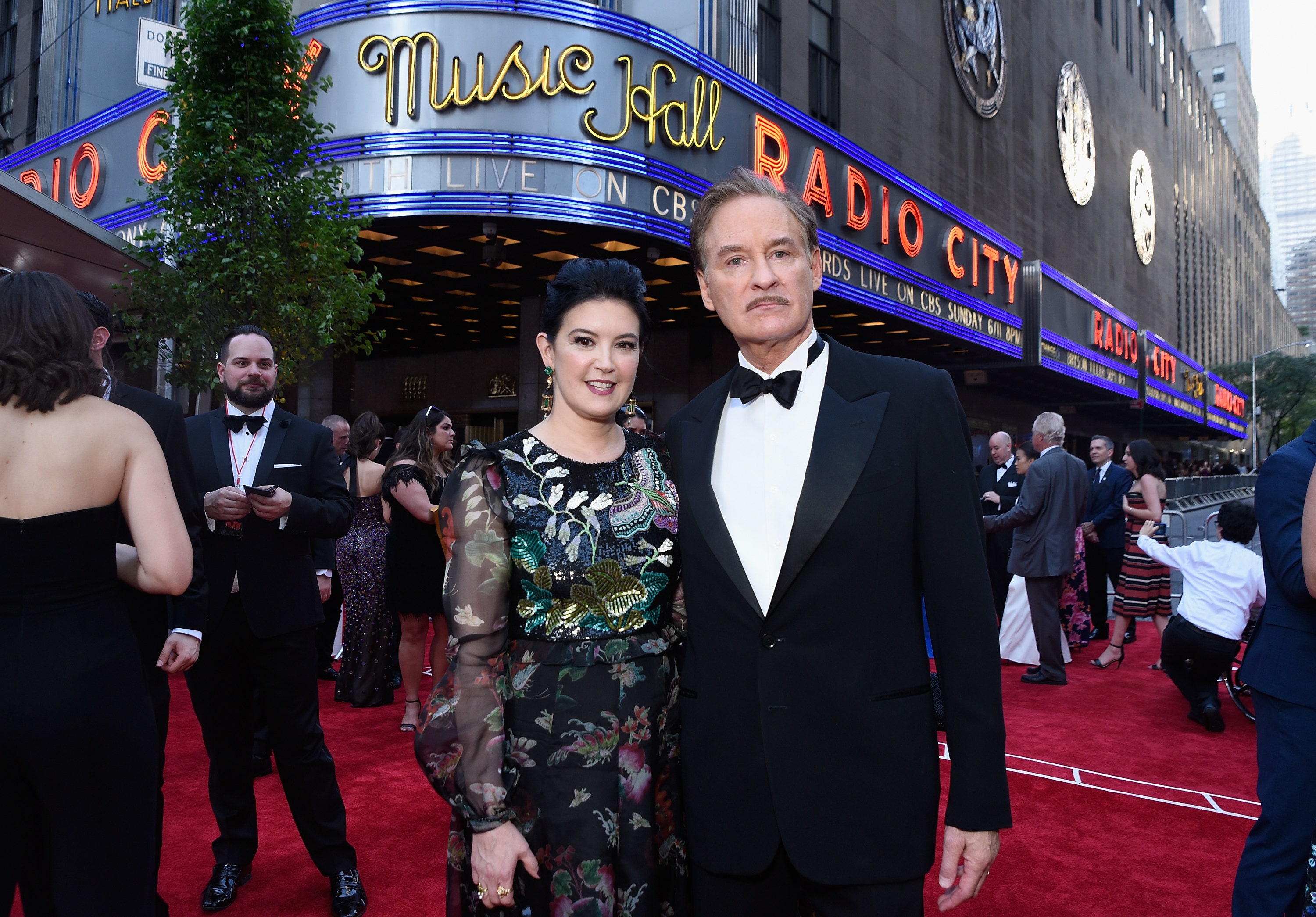 Phoebe Cates and Kevin Kline pose in front of Radio City Music Hall