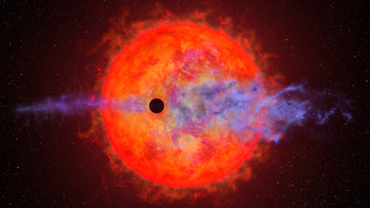 An illustration of a planet passing in front of the red dwarf star AU Microscopii