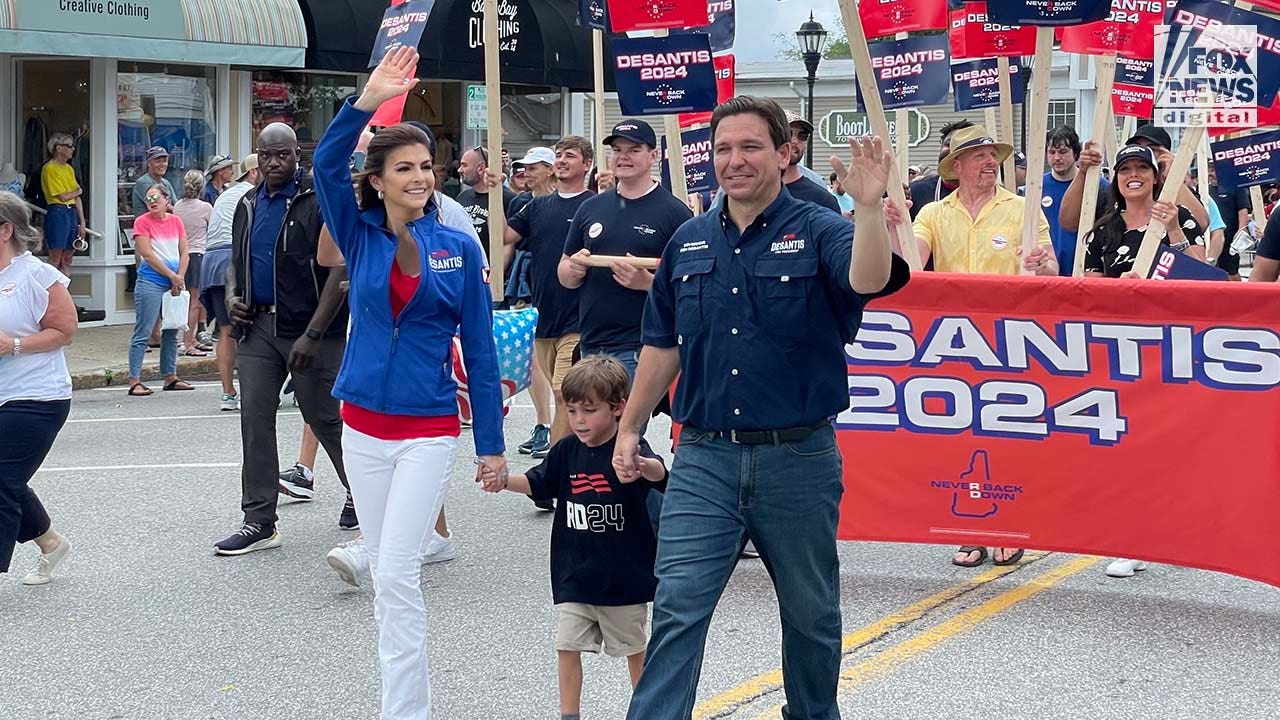 Florida Governor and presidential candidate Ron DeSantis walks alongside supporters