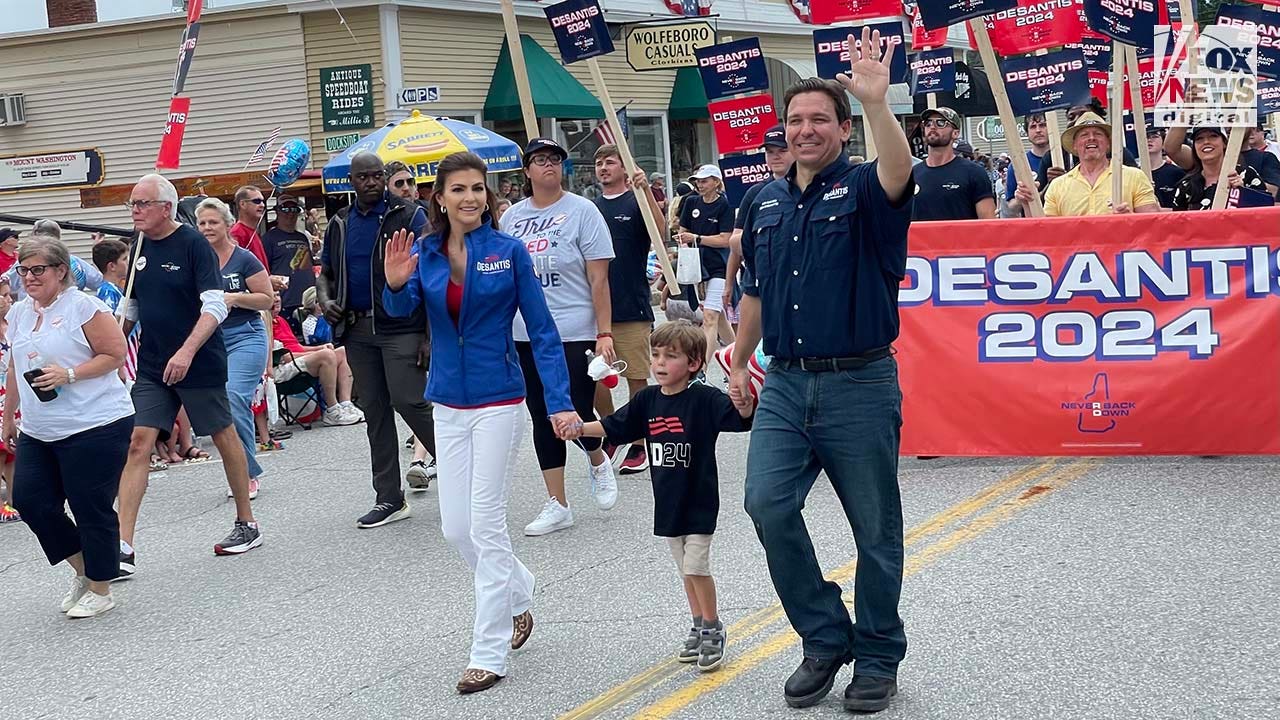 Florida Governor and presidential candidate Ron DeSantis walks alongside supporters