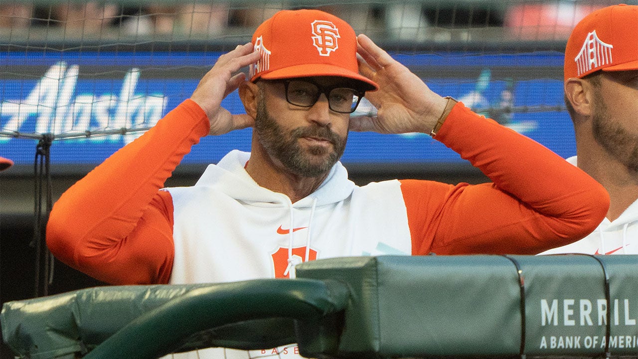 Gabe Kapler signals during the fifth inning