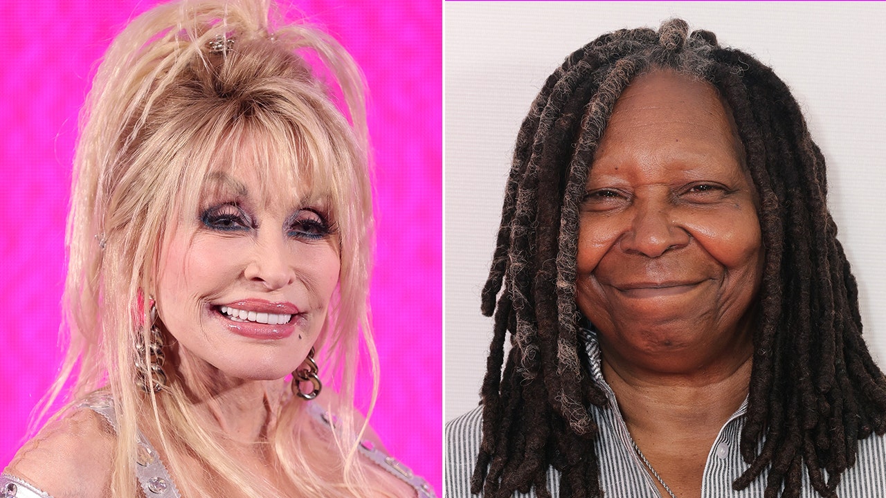 Dolly Parton smiles with a hot pink back drop split Whoopi Goldberg soft smiles on the carpet