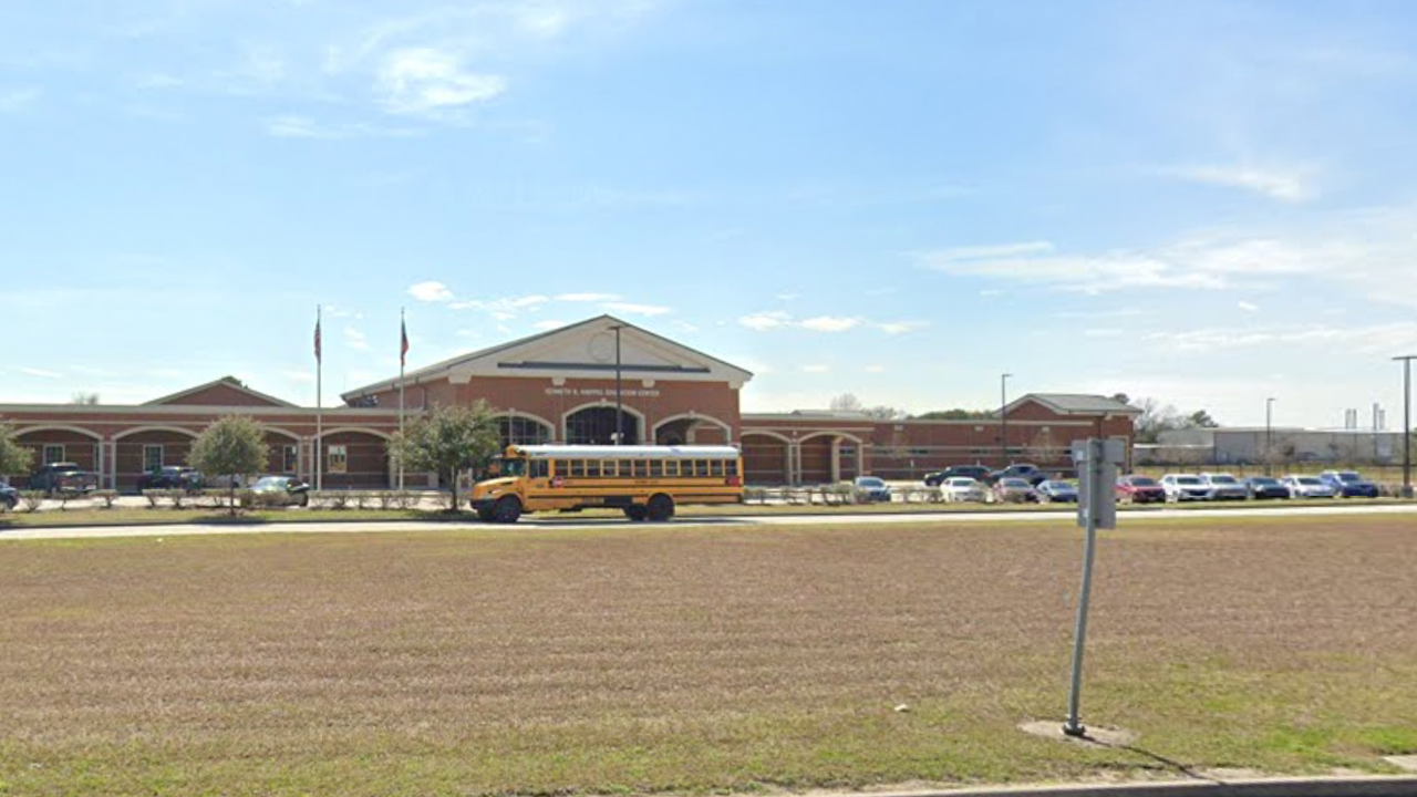 high school seen from street, bus in front