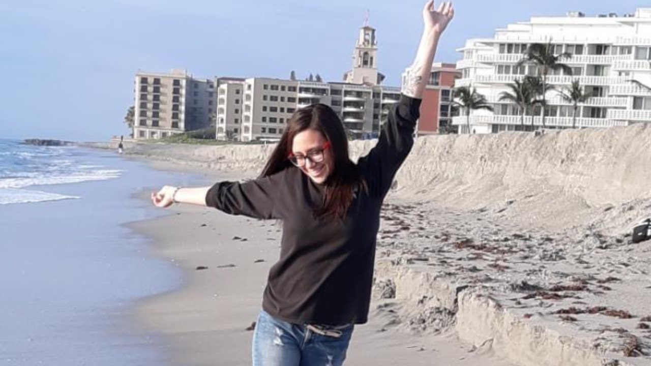 Andi Wagner poses on a beach