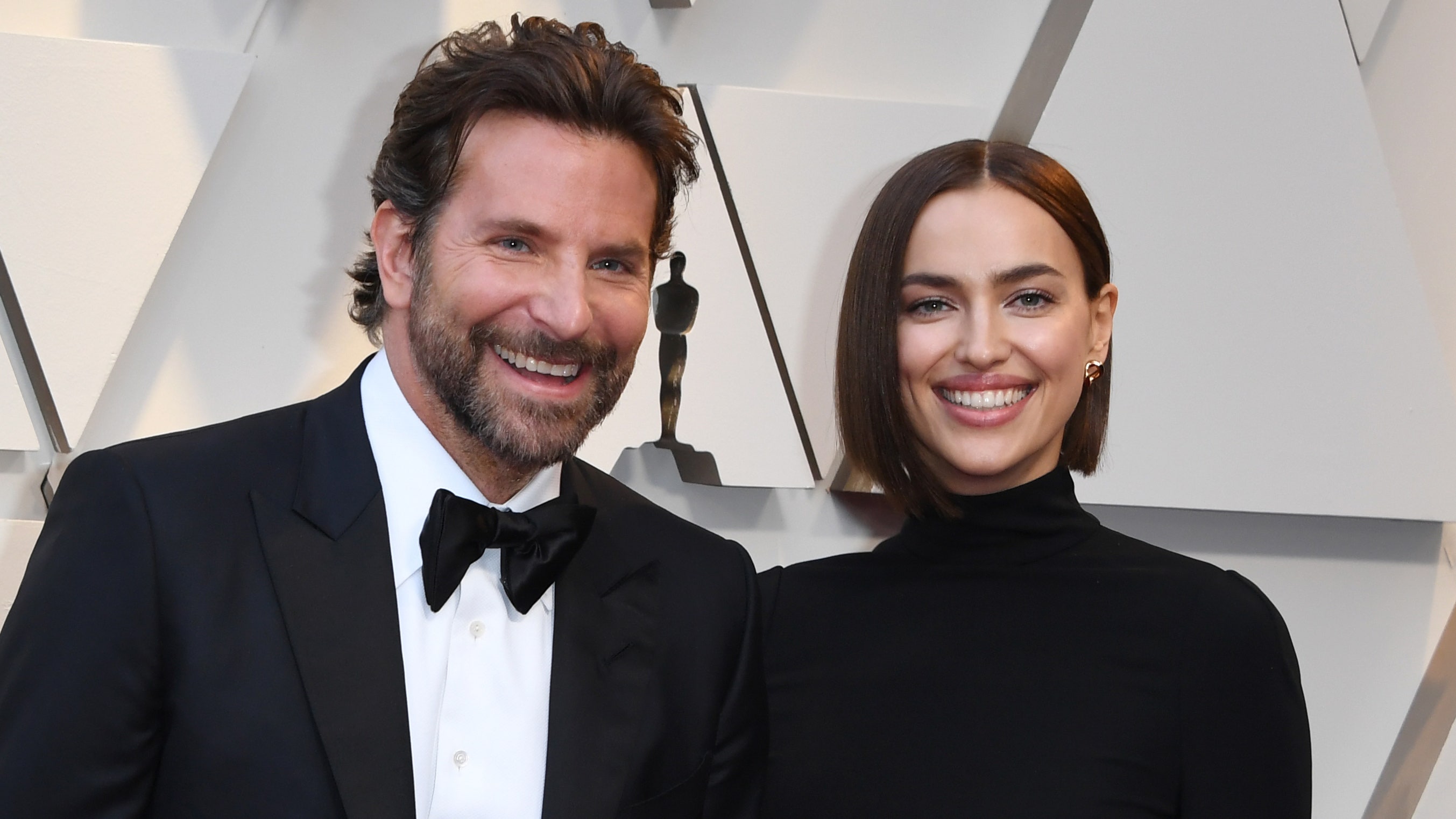 Bradley Cooper in a tuxedo and Irina Shayk in a black dress