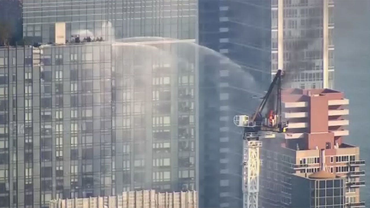 New York City construction crane catches on fire before collapse
