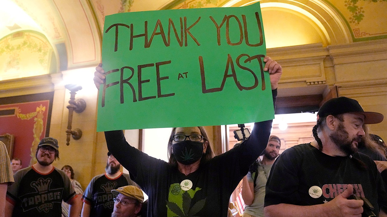 Weed supporter holds sign