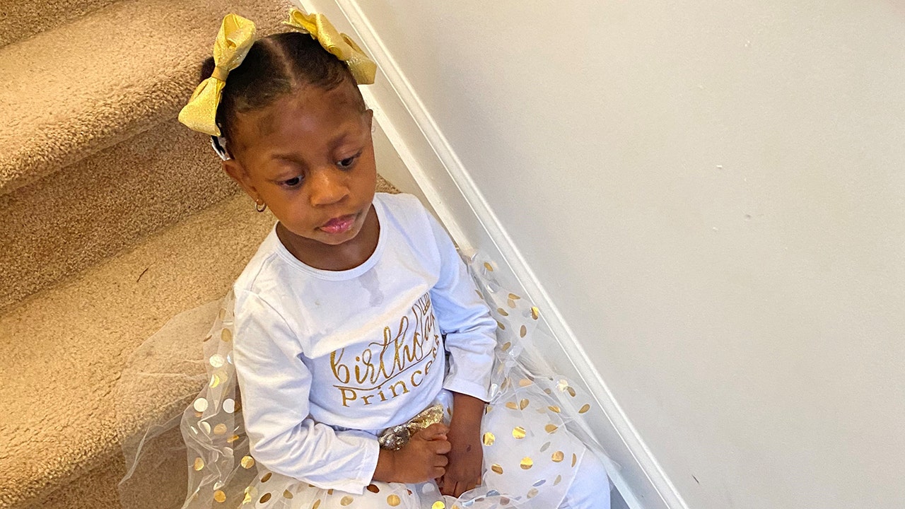 New Jersey student Fajr Williams sits on the steps in her parents' home