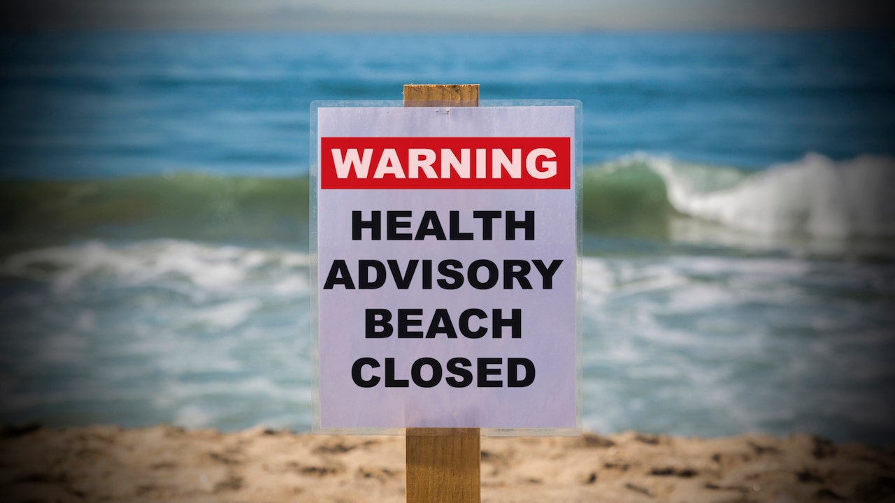 Beach advisory "Warning Health Advisory Beach Closed"