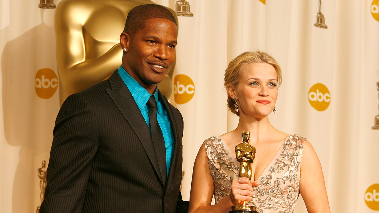 Jamie Foxx is next to Reese Witherspoon at the Academy Awards