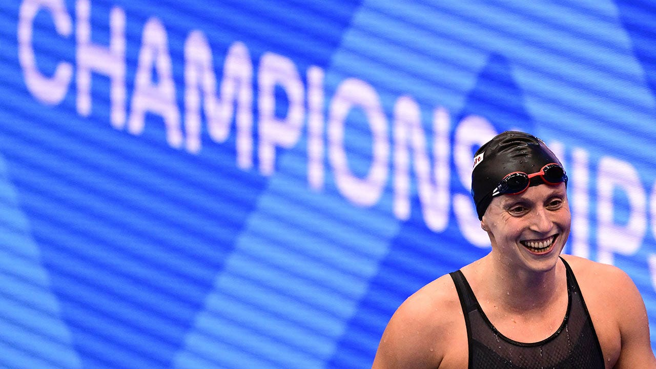 Katie Ledecky celebrates winning the 1500m freestyle.