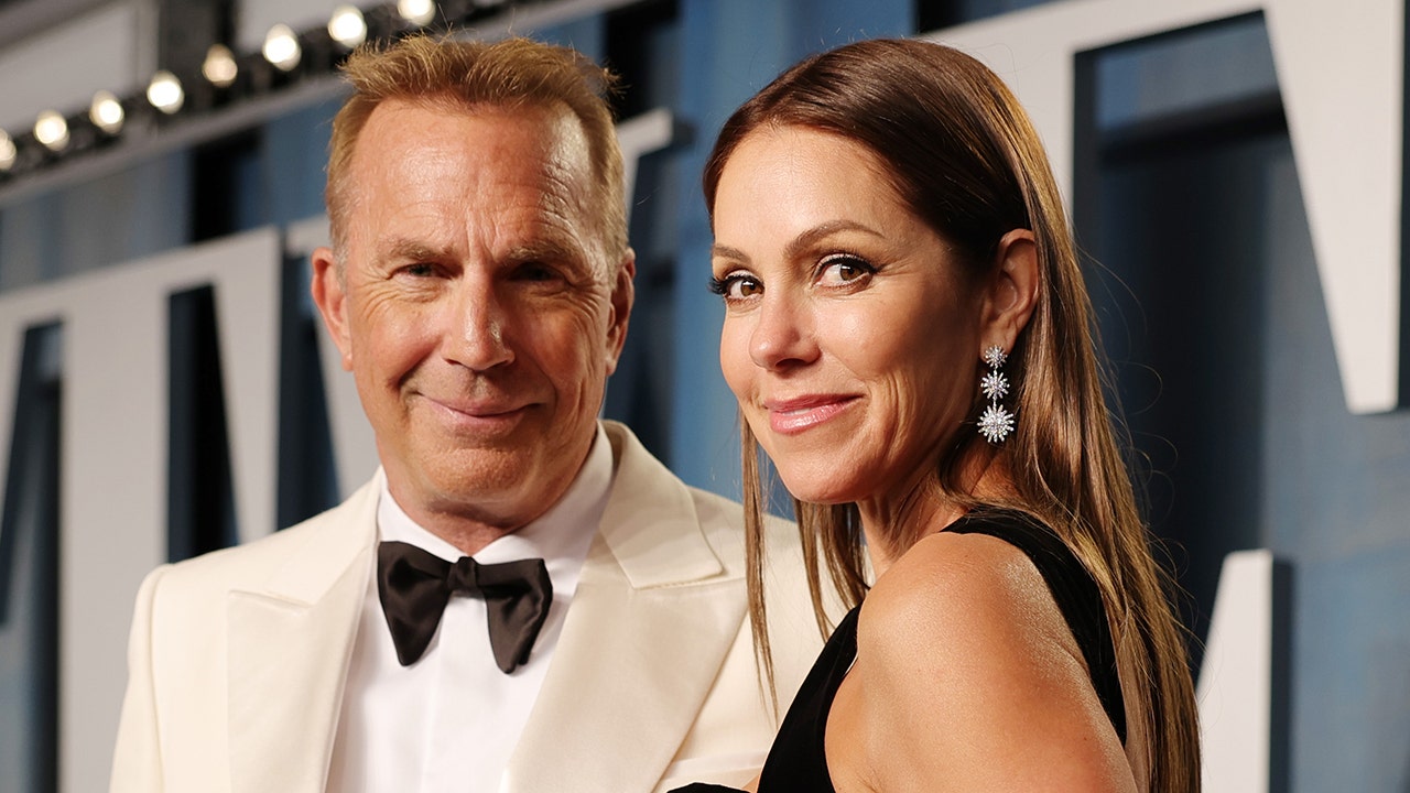 Kevin Costner wears white suit to Oscars after party with Christine Baumgartner