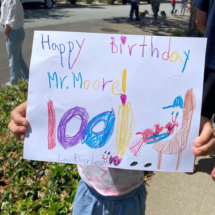 Kid holding happy birthday sign