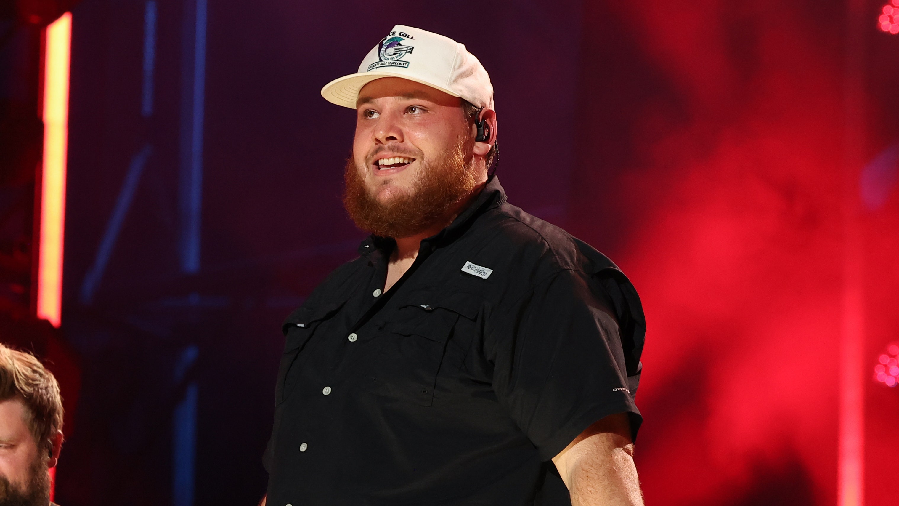 Luke Combs smiles on stage