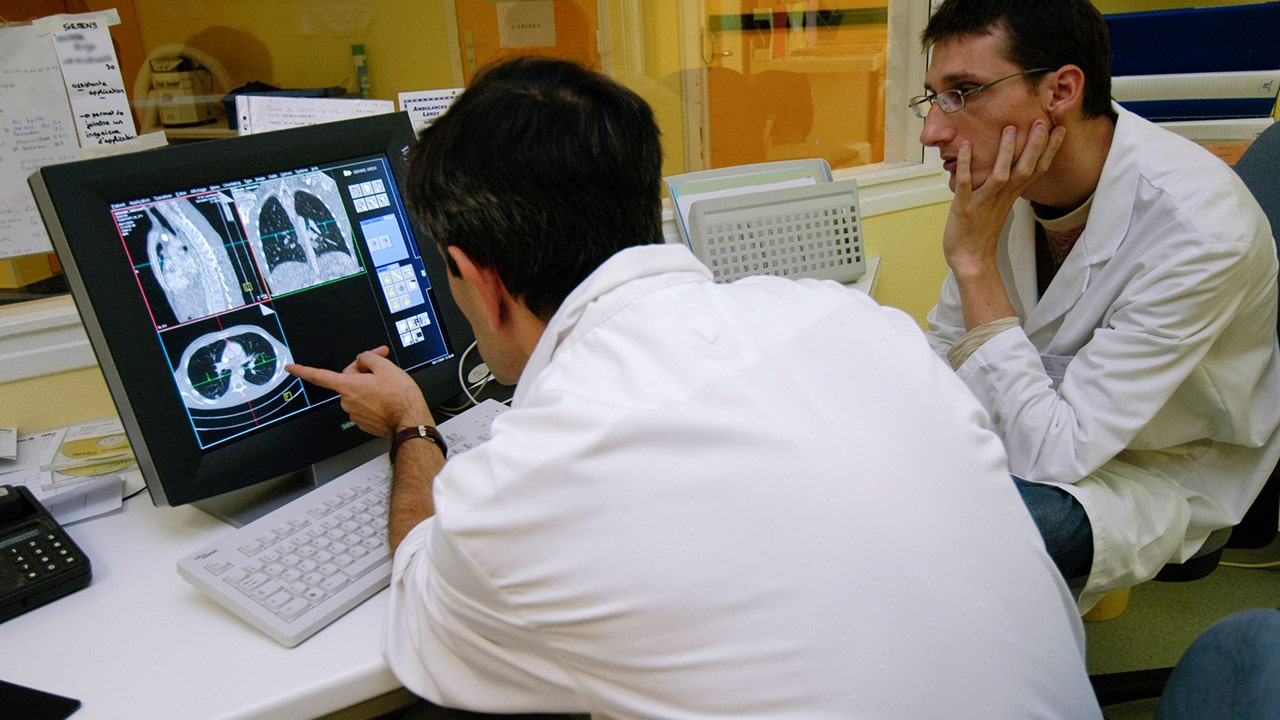 Doctors looking at a lung cancer scan