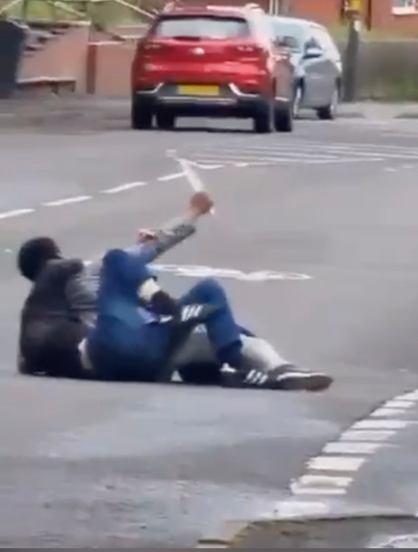Man fends off attacker who tries to stab him as shocked onlookers shout for help: video