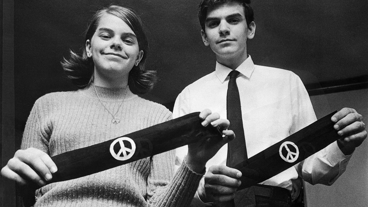 Mary Beth and John Tinker hold black armbands