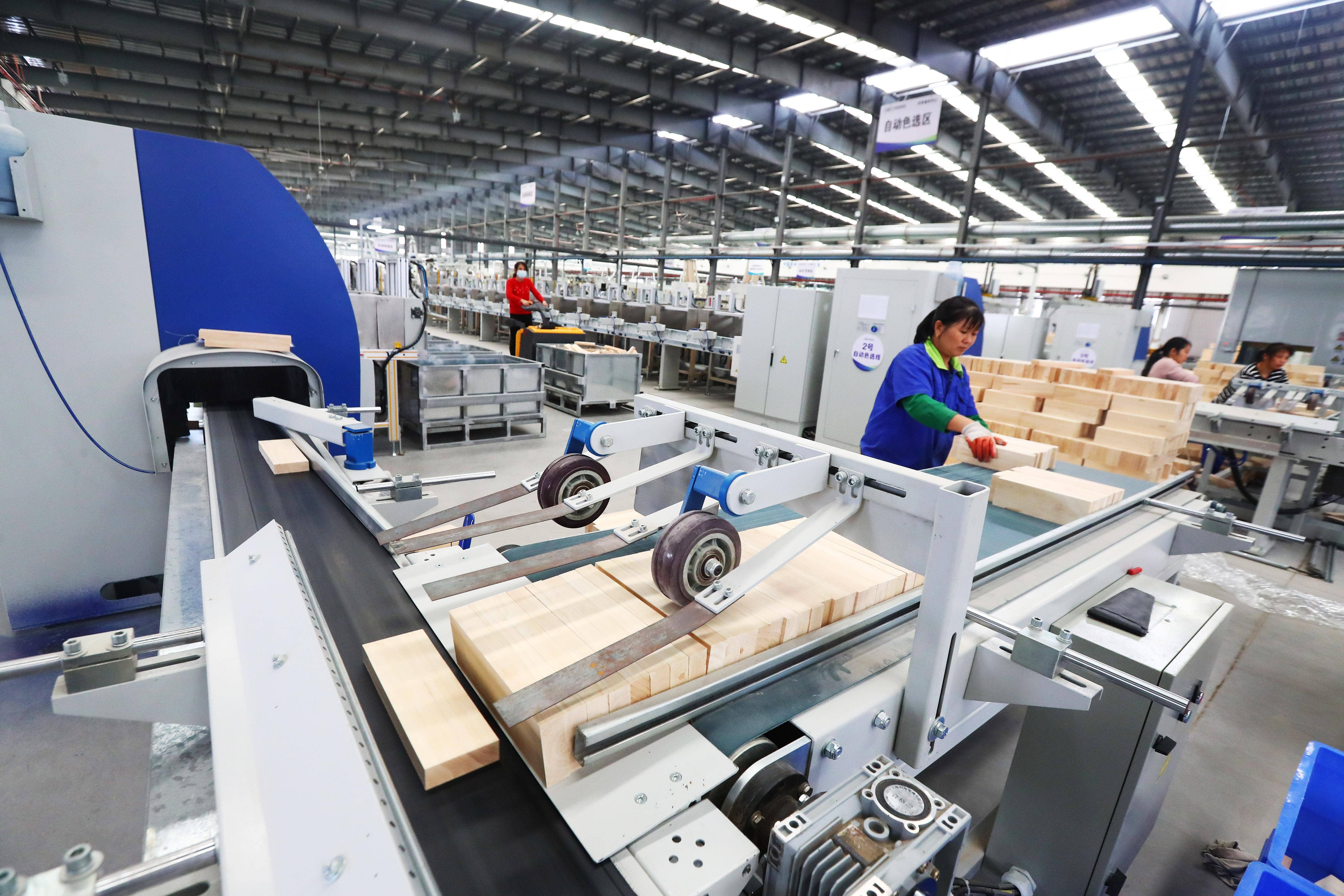 Employees work at an intelligent furniture factory using 5G and artificial intelligence technologies on Oct. 21, 2020, in Ganzhou, Jiangxi Province of China. (Liu Zhankun/China News Service via Getty Images)