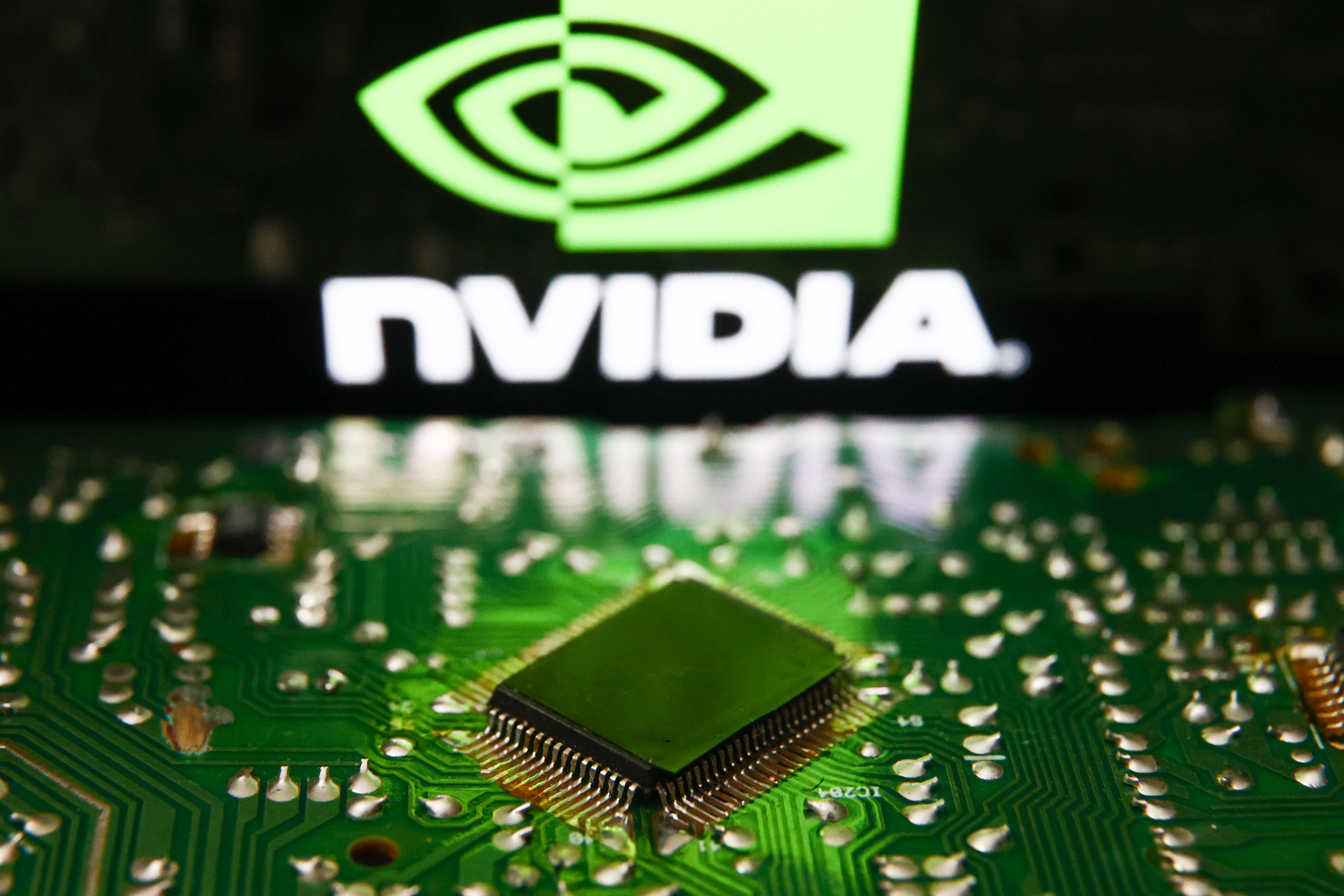 Nvidia logo displayed on a phone screen and microchip and are seen in this illustration photo taken in Krakow, Poland on July 19, 2023. (Jakub Porzycki/NurPhoto via Getty Images)