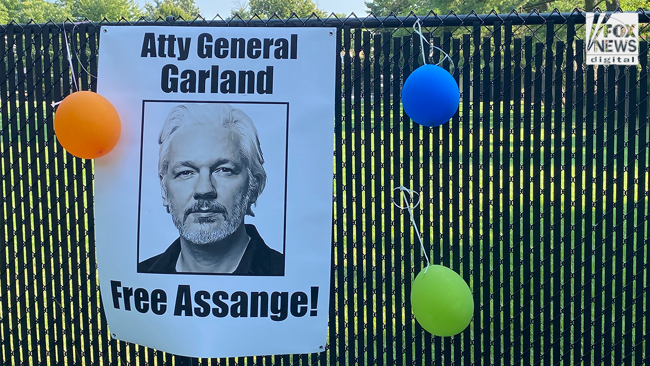 Julian Assange supporters demand charges be dropped in vigil outside Merrick Garland’s home