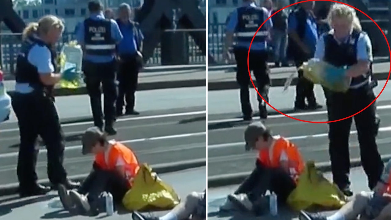 German police officer accused of dumping oil on radical climate protesters that blocked, glued hands to road