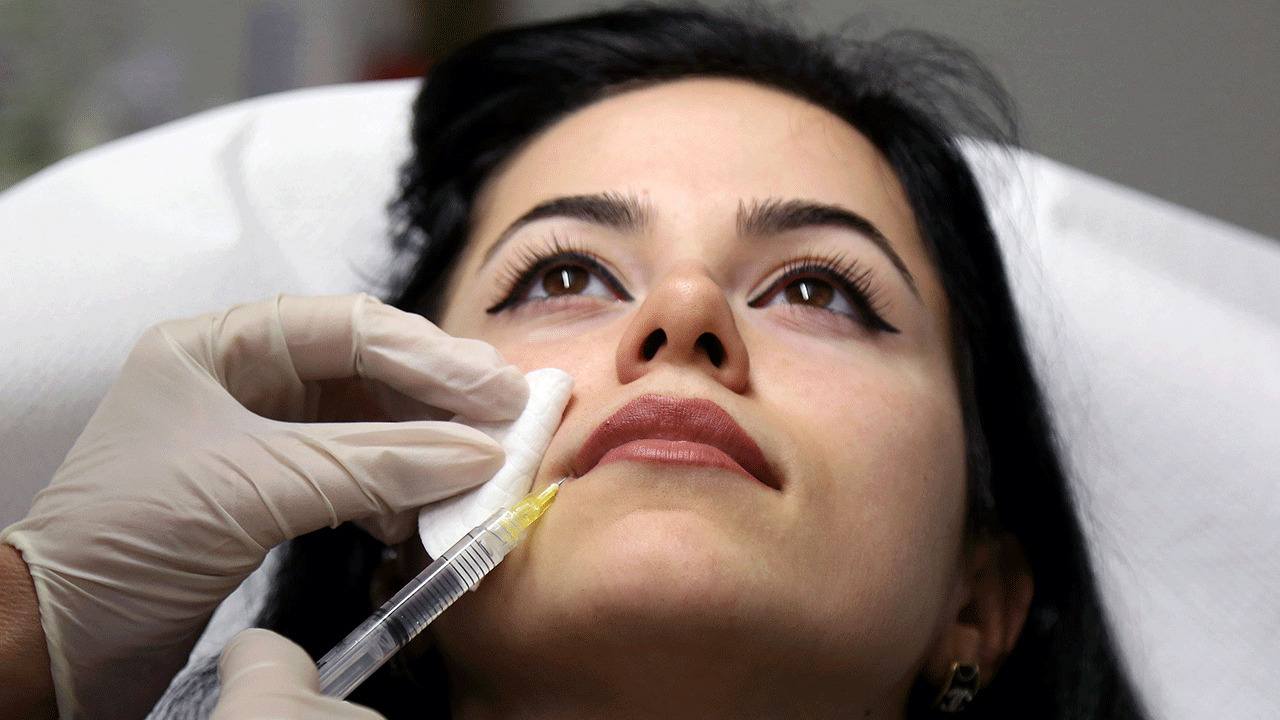 Woman receiving lip injections