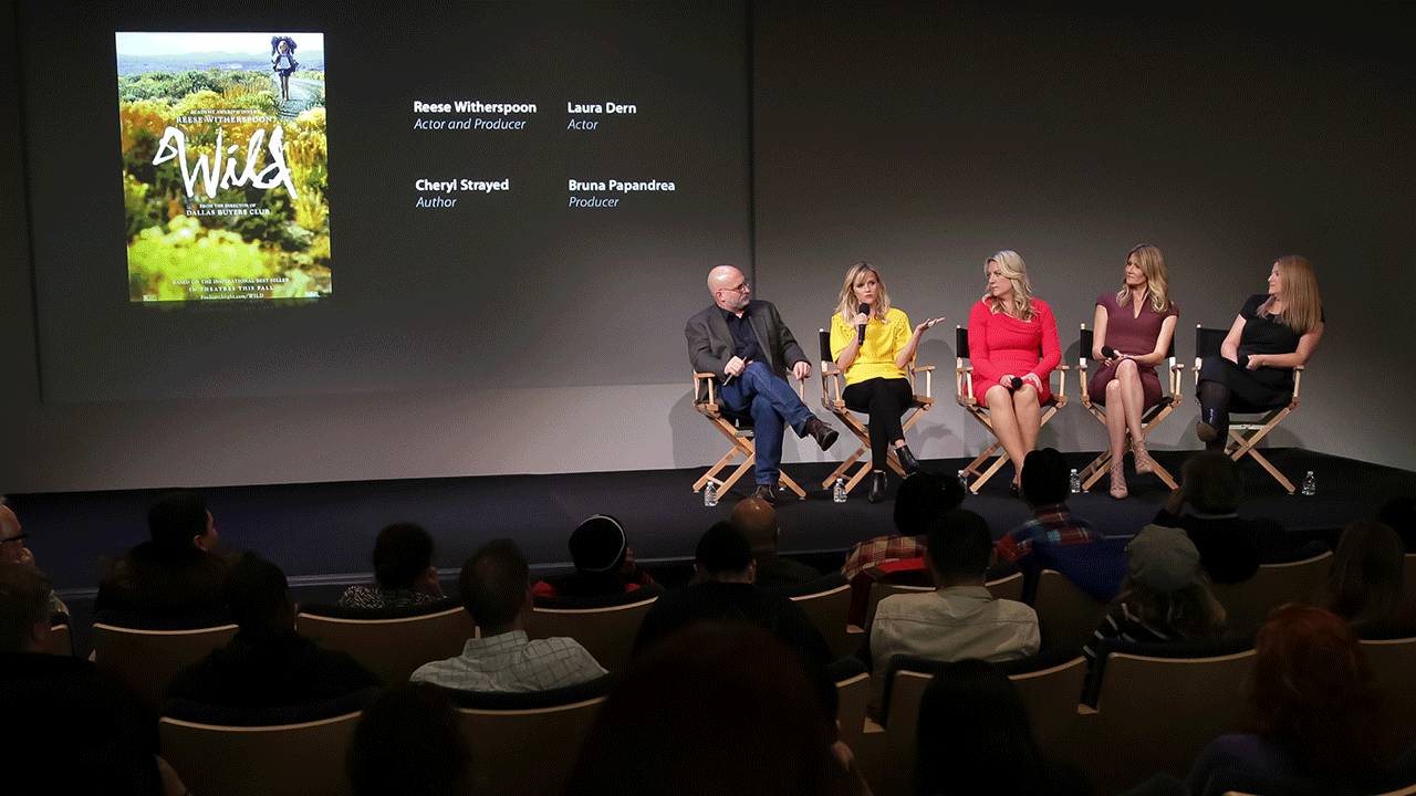 Journalist Joe Neumaier, actress Reese Witherspoon, author Cheryl Strayed, actress Laura Dern and producer Bruna Papandrea on stage speaking about "Wild"