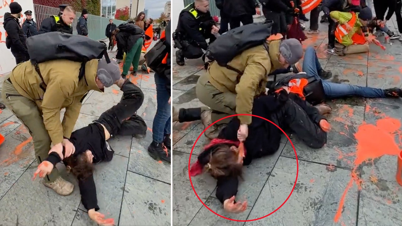 German police officer accused of painting climate activist's face with orange paint after slamming to ground