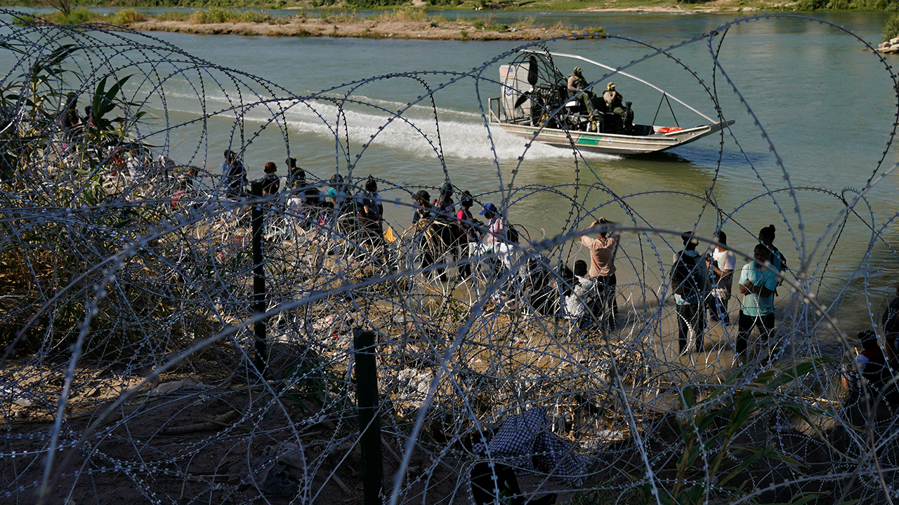 Migrants are met with barbed wire