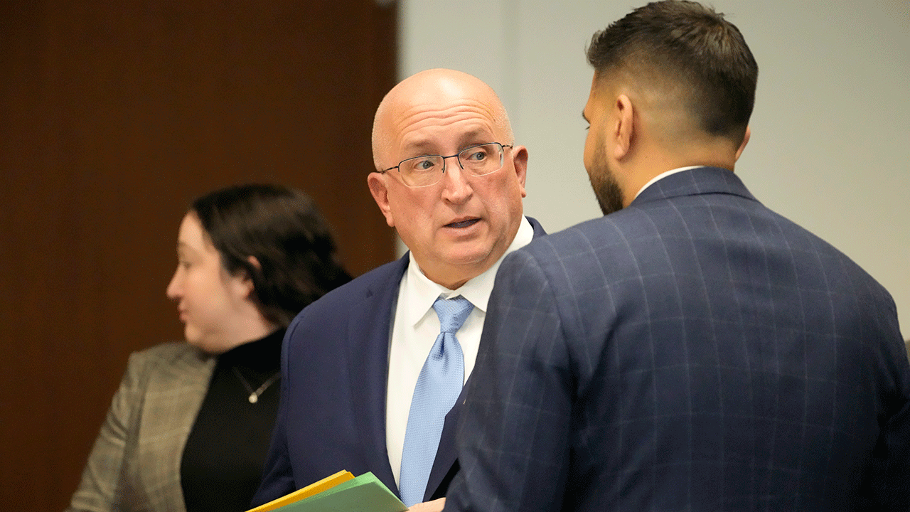 Robert E. Crimo Jr. talks to his attorney